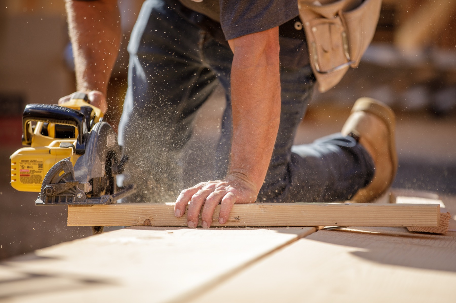 A Stud Finder carpenter cutting framing lumber on site
