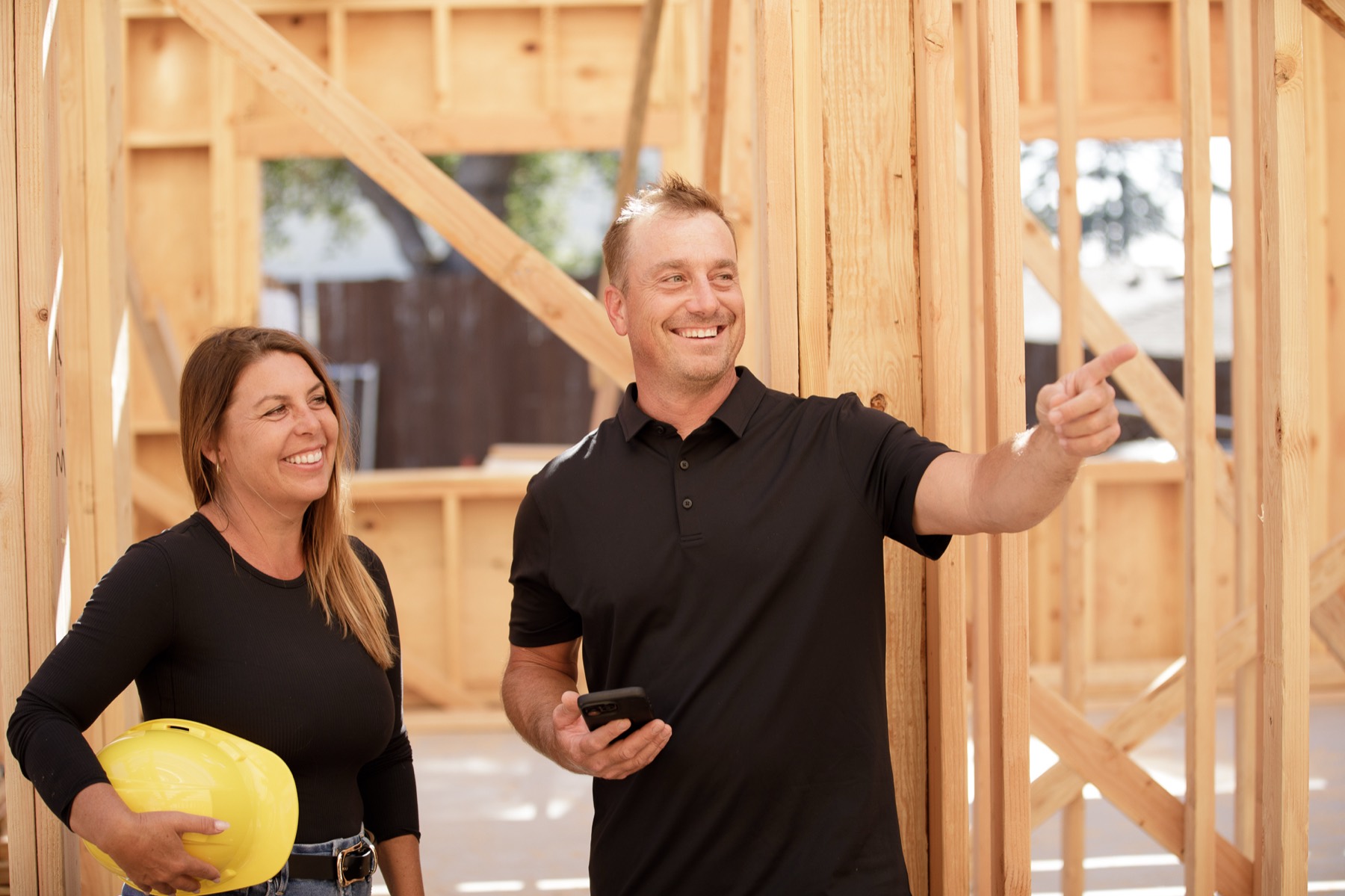 Rachael and Erik walking a framed job site in Santa Barbara